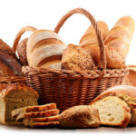 wicker basket with assorted baking products isolated on white background